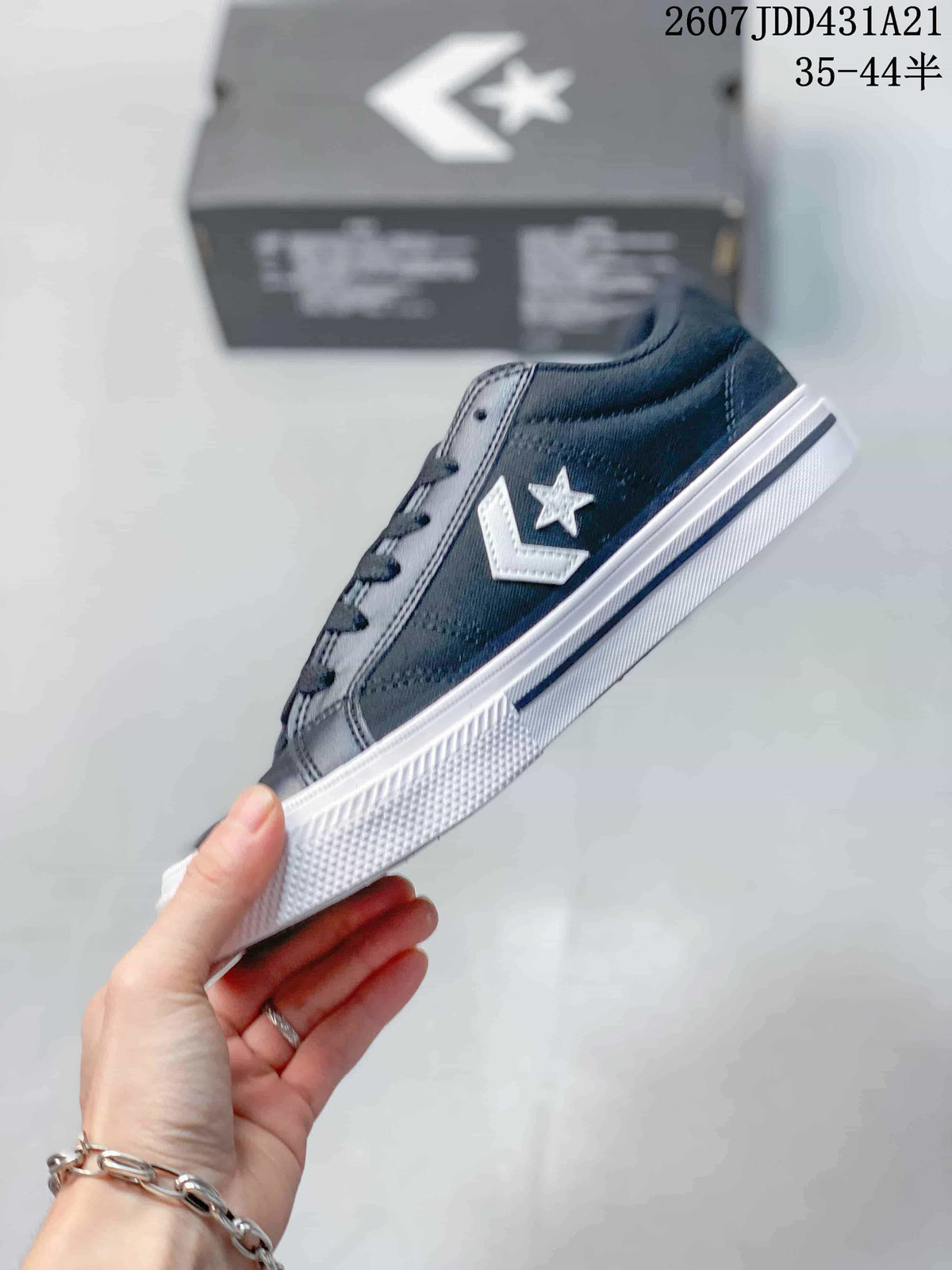 Side profile of a navy low-top sneaker showing the white star-and-chevron logo and layered white outsole.