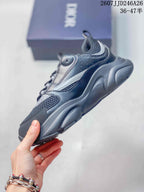 Side view of the Dior sneaker showing layered panels, mesh-look sections, silver-gray accents, and a thick outsole.