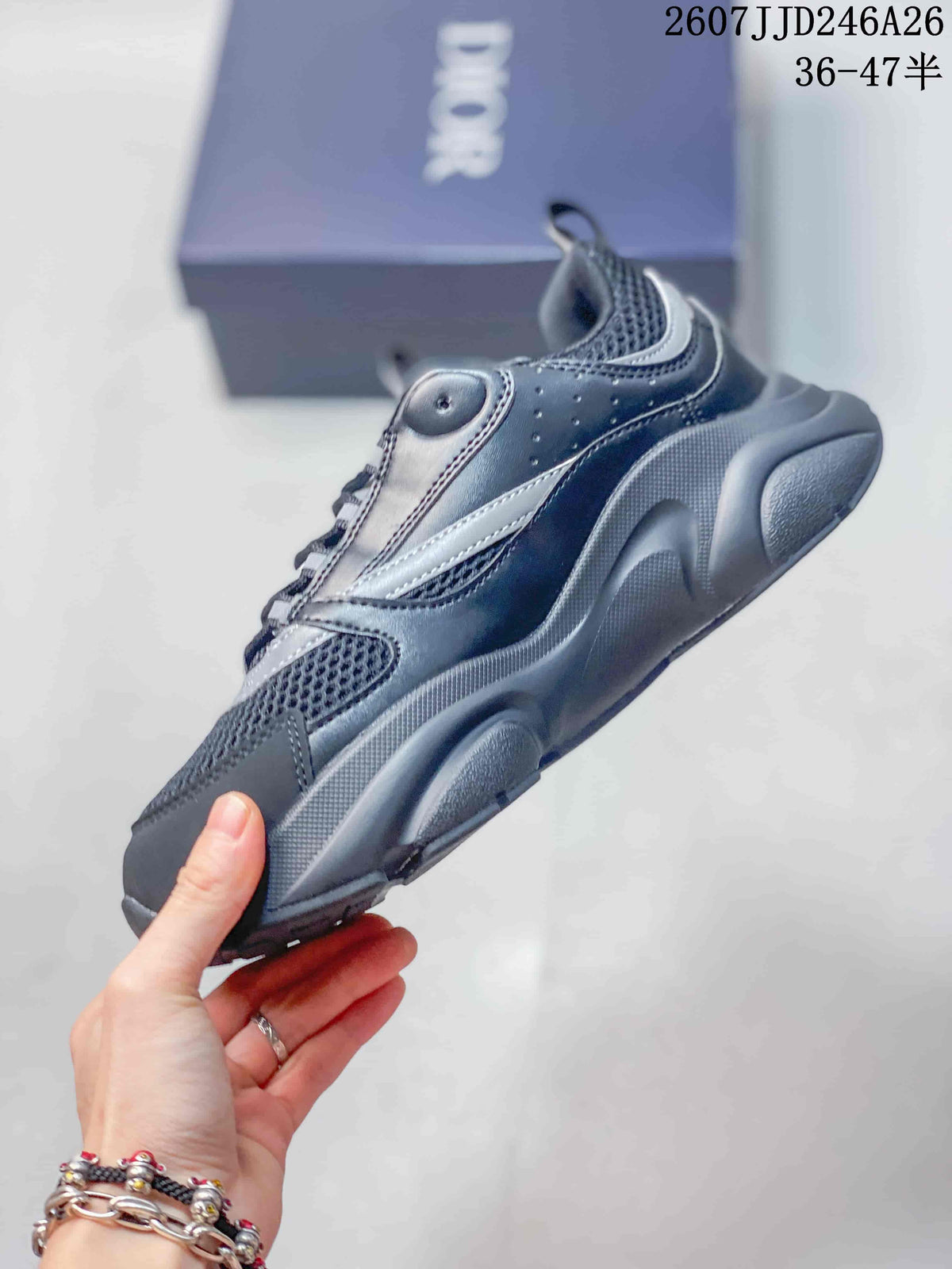 Side view of the Dior sneaker showing layered panels, mesh-look sections, silver-gray accents, and a thick outsole.