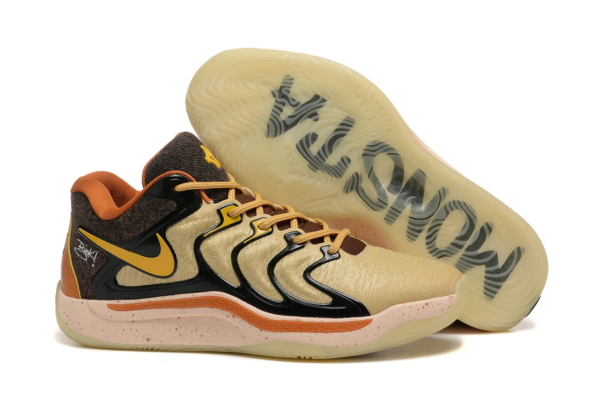 Brown and black Nike KD 17 basketball shoes with gold accents and a translucent outsole.