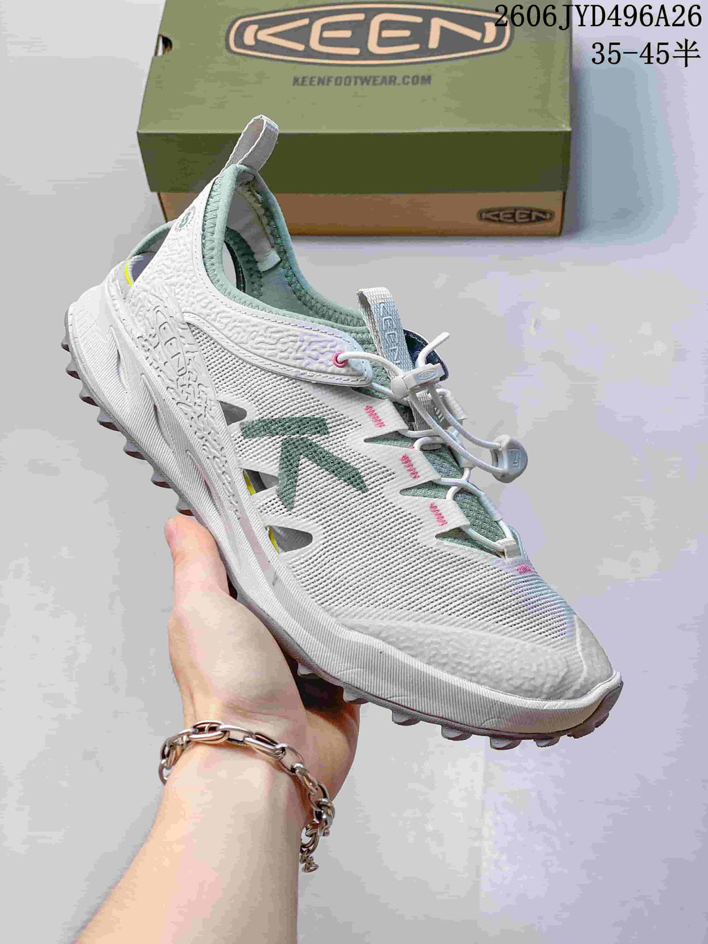 Side view of a white Keen Zionic ADV hiking shoe with green accents and a quick-lacing cord system