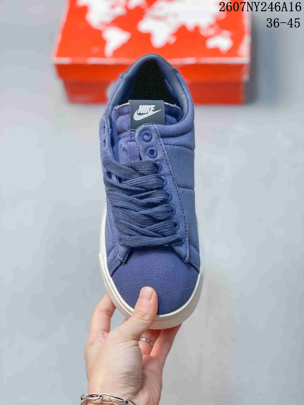 Front view of the blue lace-up sneaker showing the Nike tongue label and rounded toe.