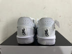 Rear view of white Nike basketball shoes with perforated heel panels and black details.