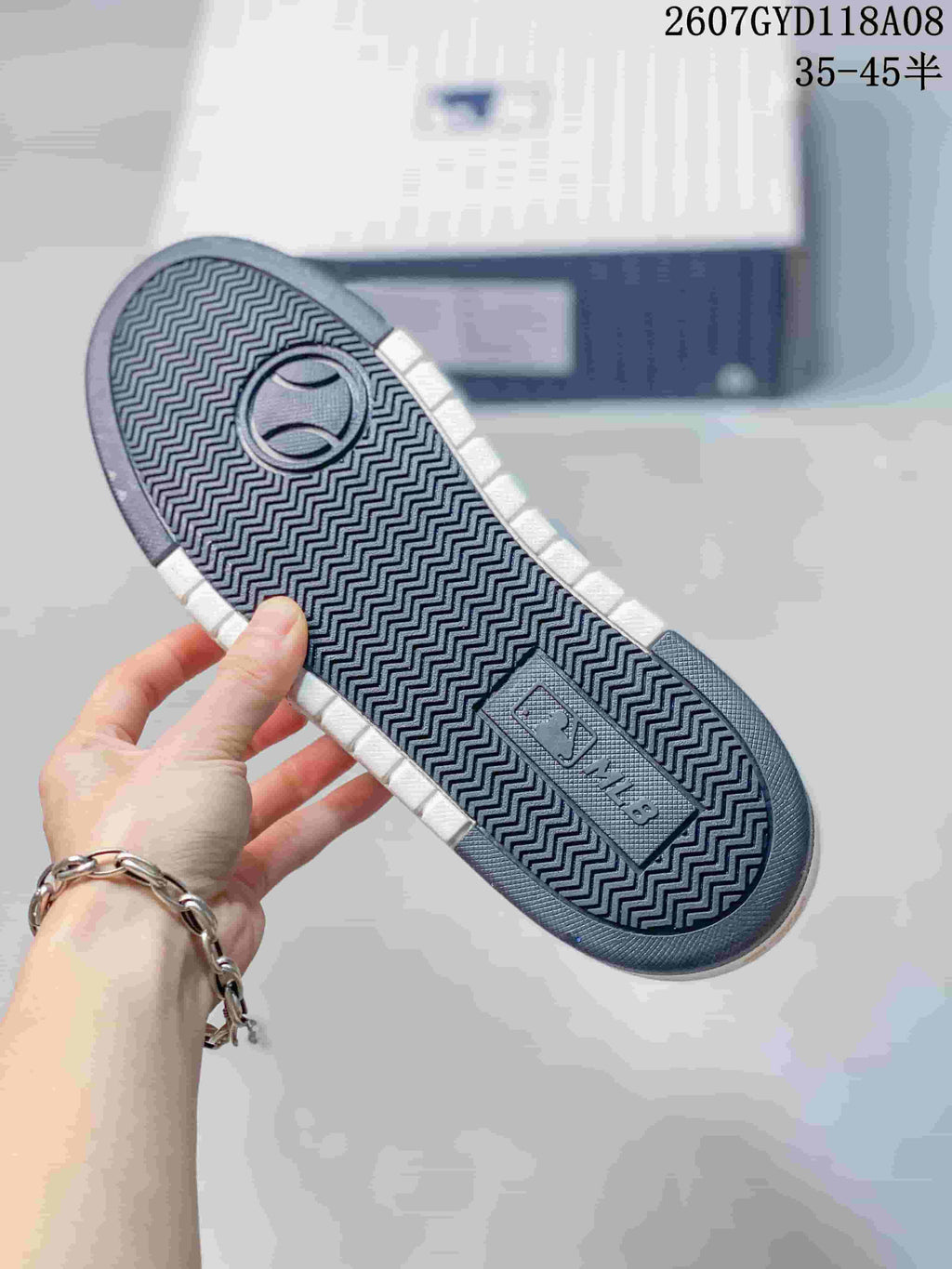 Bottom view of the sneaker showing a dark zigzag-patterned outsole and MLB branding.