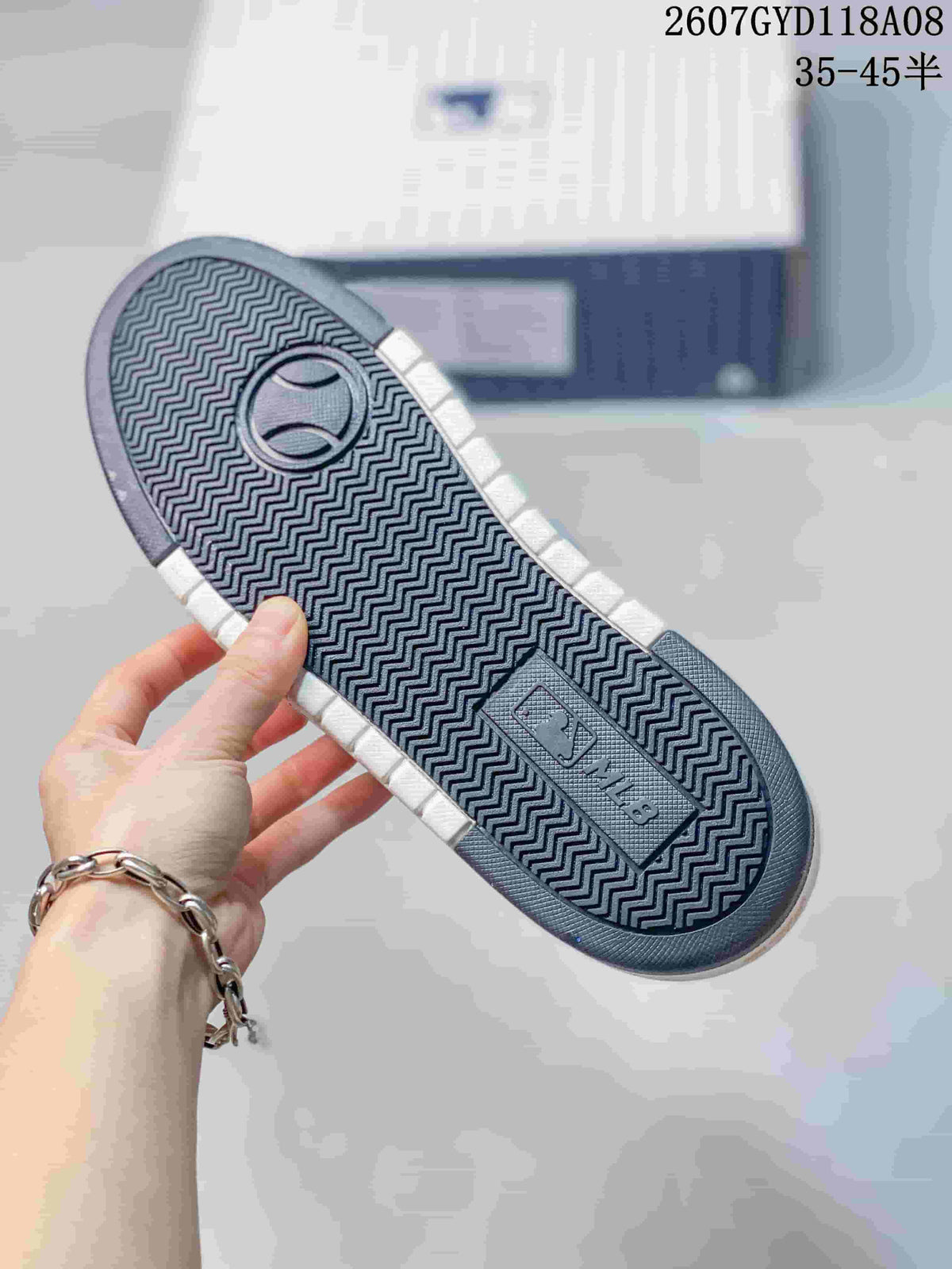Bottom view of the sneaker showing a dark zigzag-patterned outsole and MLB branding.