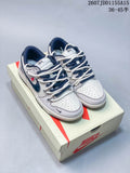 Pair of gray, white, and navy Nike SB Dunk Low sneakers displayed on a Nike shoebox; overlay shows style code 2607JDD1155A15 and size range 36–45.