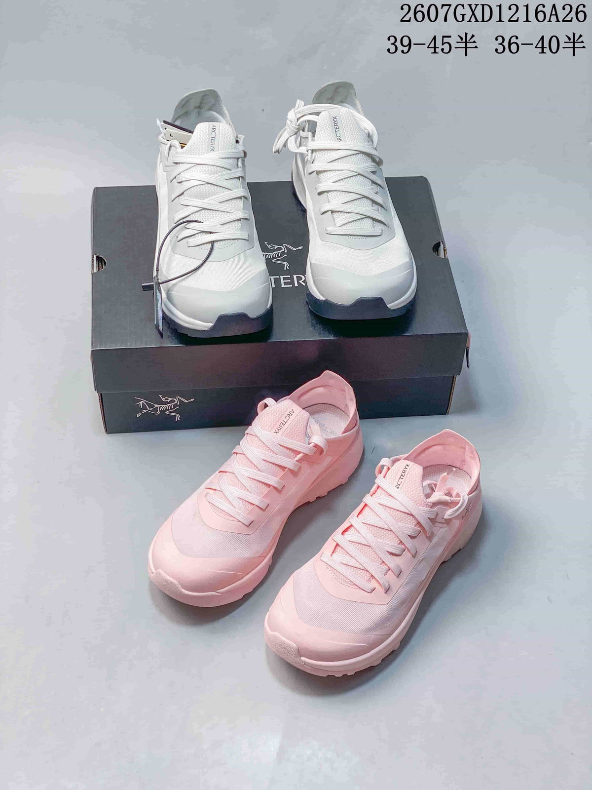 White and pink Arc'teryx Sylan shoes arranged together with a shoe box.