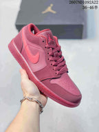 Monochrome pink low-top Jordan sneaker with matching laces, overlays, and outsole.