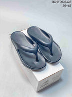Pair of black New Balance NB5601 flip-flop sandals displayed on a shoe box; size range 36–45 is visible in the upper-right corner.