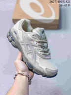 White ASICS GEL-Kayano 14 sneaker with subtle pastel detailing.