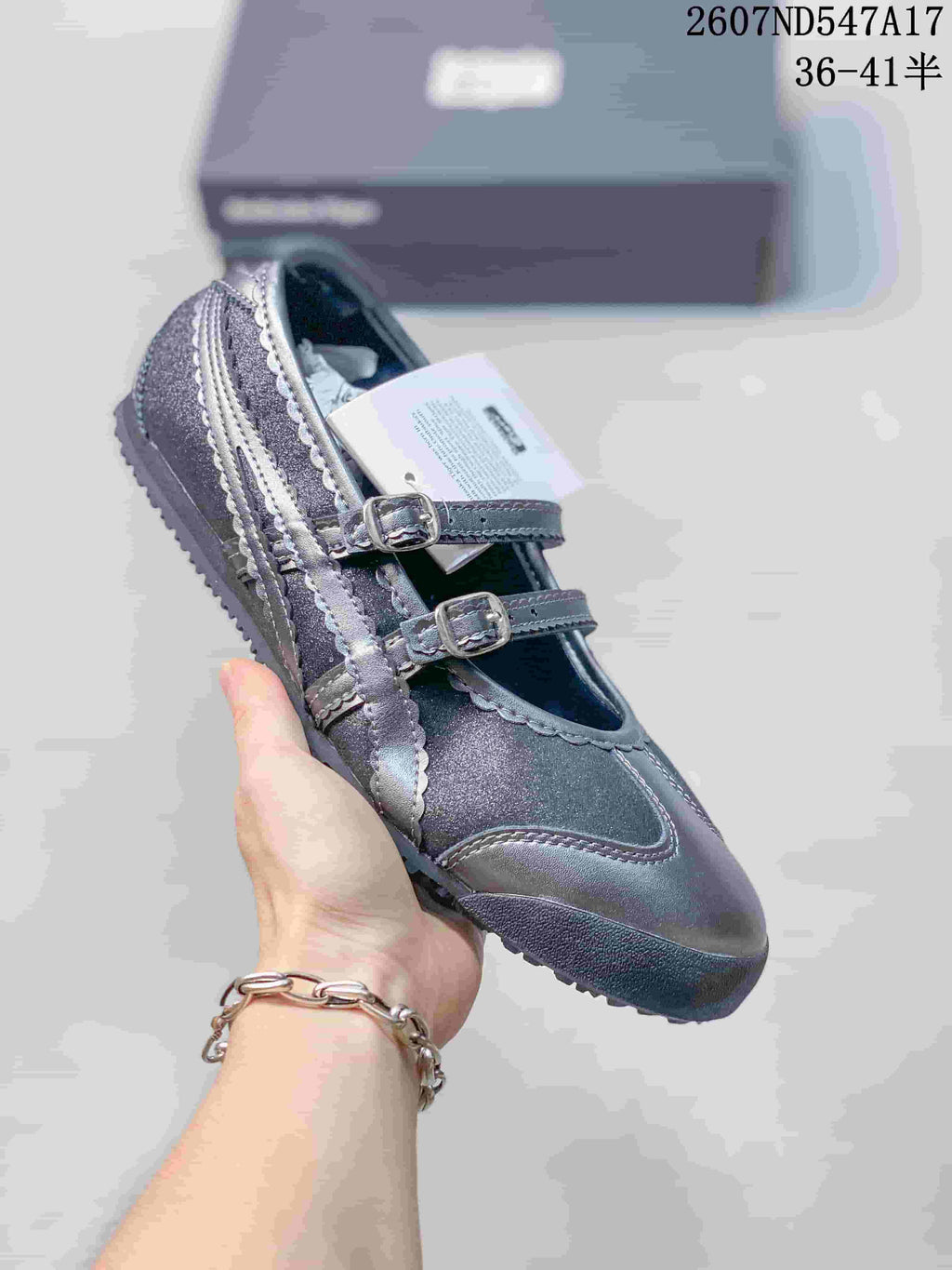 Dark gray Mary Jane sneaker with tonal side stripes and two silver-tone buckles.