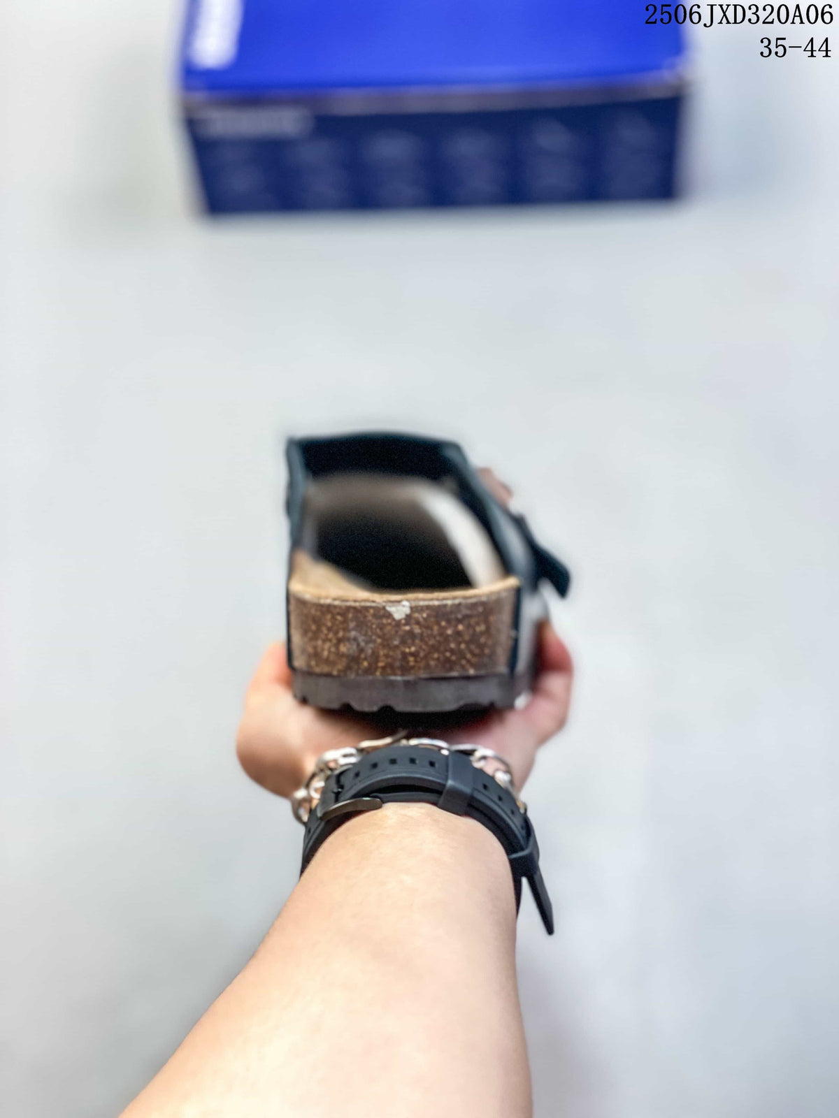 Rear view of the black clog showing the raised heel area and layered sole construction.