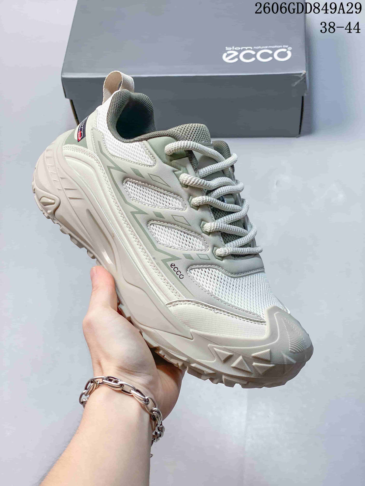 Angled view of the sneaker upper, mesh panels, and treaded outsole