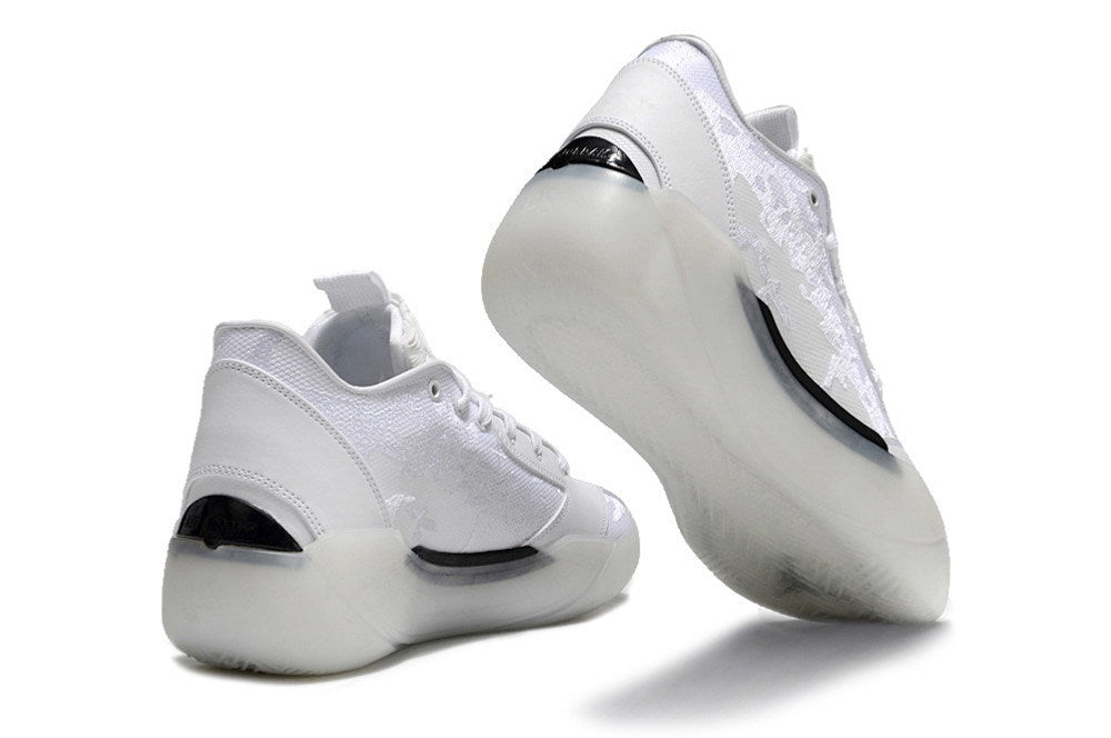 White Jordan low-top sneakers shown from the rear and outsole.