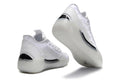 White Jordan low-top sneakers shown from the rear and outsole.
