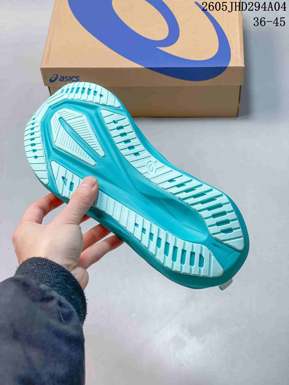 Underside of a turquoise running shoe showing the tread pattern