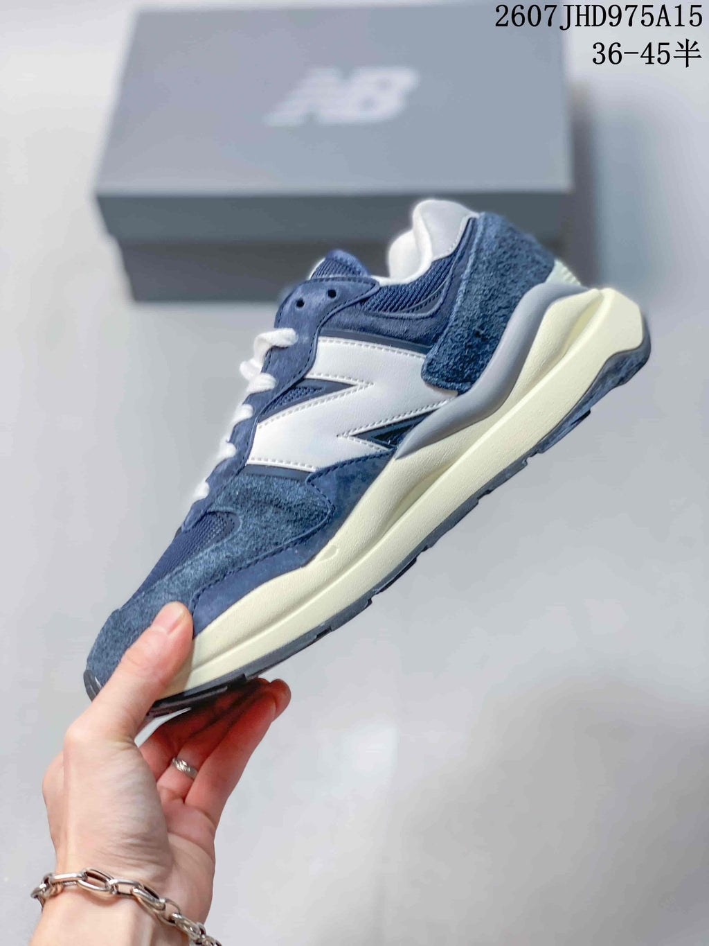 Side profile highlighting the navy and white layered upper and chunky cream-colored midsole.