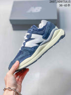 Side profile highlighting the navy and white layered upper and chunky cream-colored midsole.