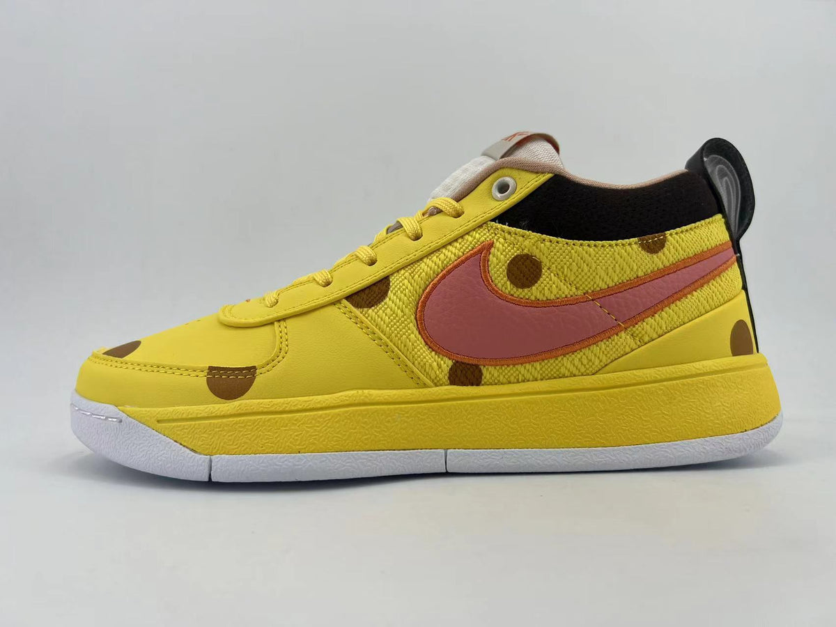 Yellow low-top sneaker with brown spots, pink side Swoosh, black collar lining, and white outsole