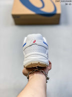 Rear view of a white and blue ASICS sneaker showing the mesh heel panel, padded collar, and outsole.