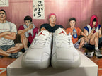Front view of white lace-up basketball shoes with red tongue emblems