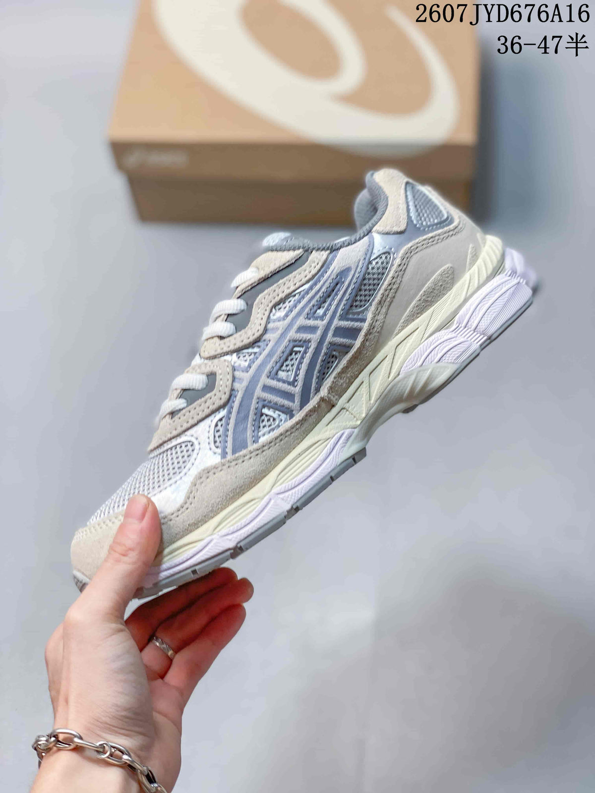 Side view of the gray, cream, and muted blue sneaker showing the layered upper and textured midsole.