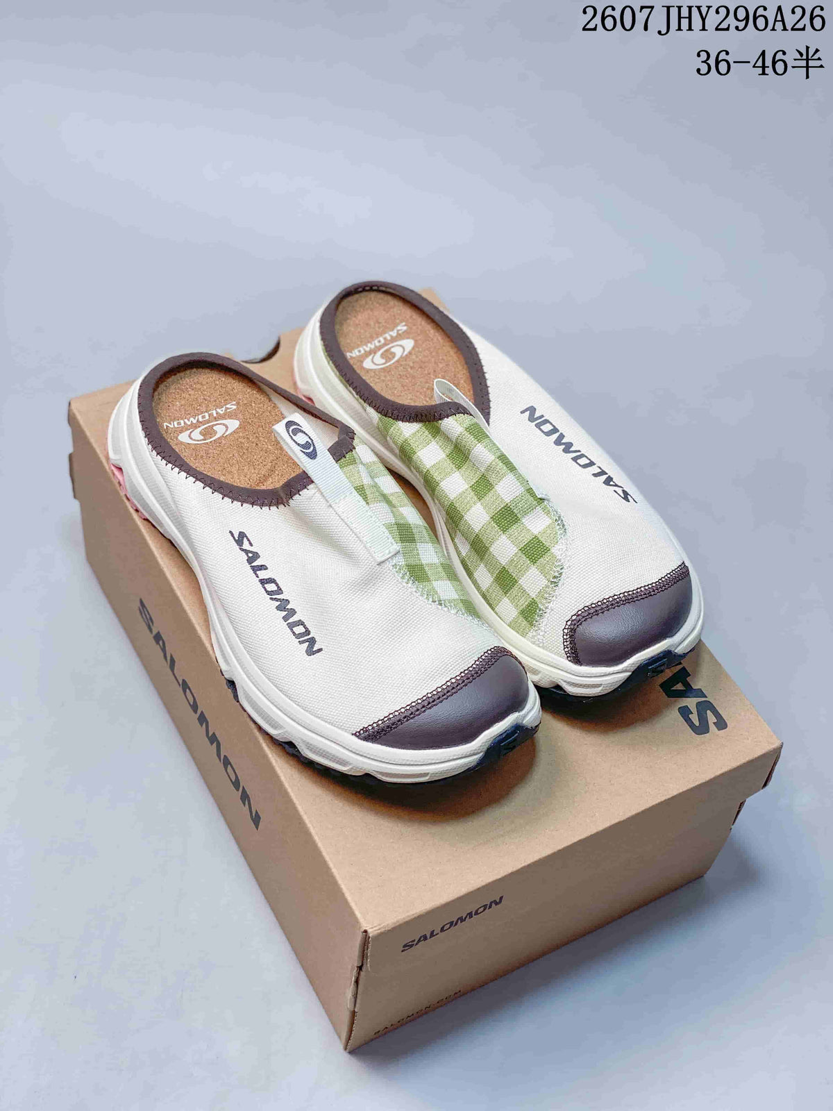 Pair of Salomon RX Slide 3.0 closed-toe slip-ons displayed on a branded box, showing the white upper, green check-pattern panels and dark trim.