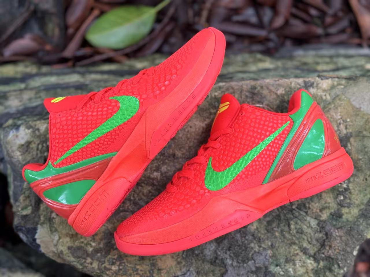 Angled pair view of red Nike Kobe 6 shoes with green swooshes