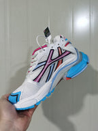 Side view of the multicolor Runner sneaker showing the mesh panels, contrasting overlays, laces and blue outsole details.