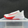 Side view of a white Nike Precision 7 basketball shoe with red accents and patterned outsole