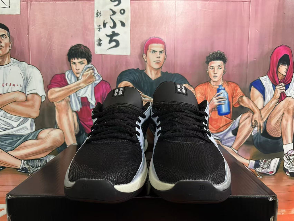 Front view of black lace-up sneakers with silver accents