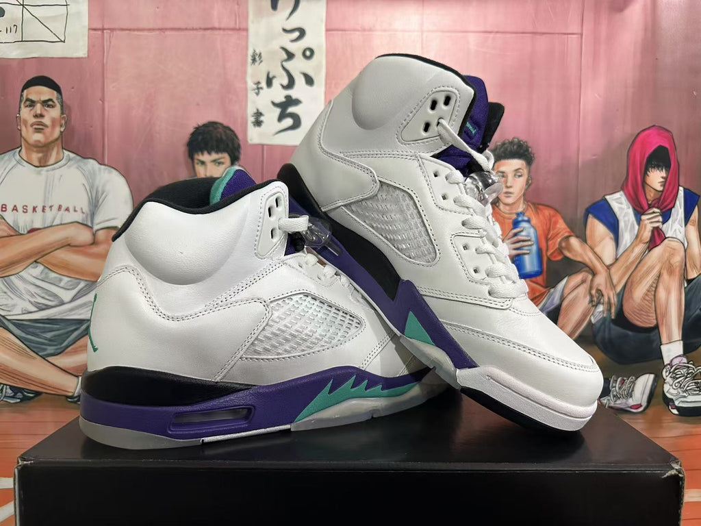 Angled view of a pair of white high-top sneakers with purple and teal accents