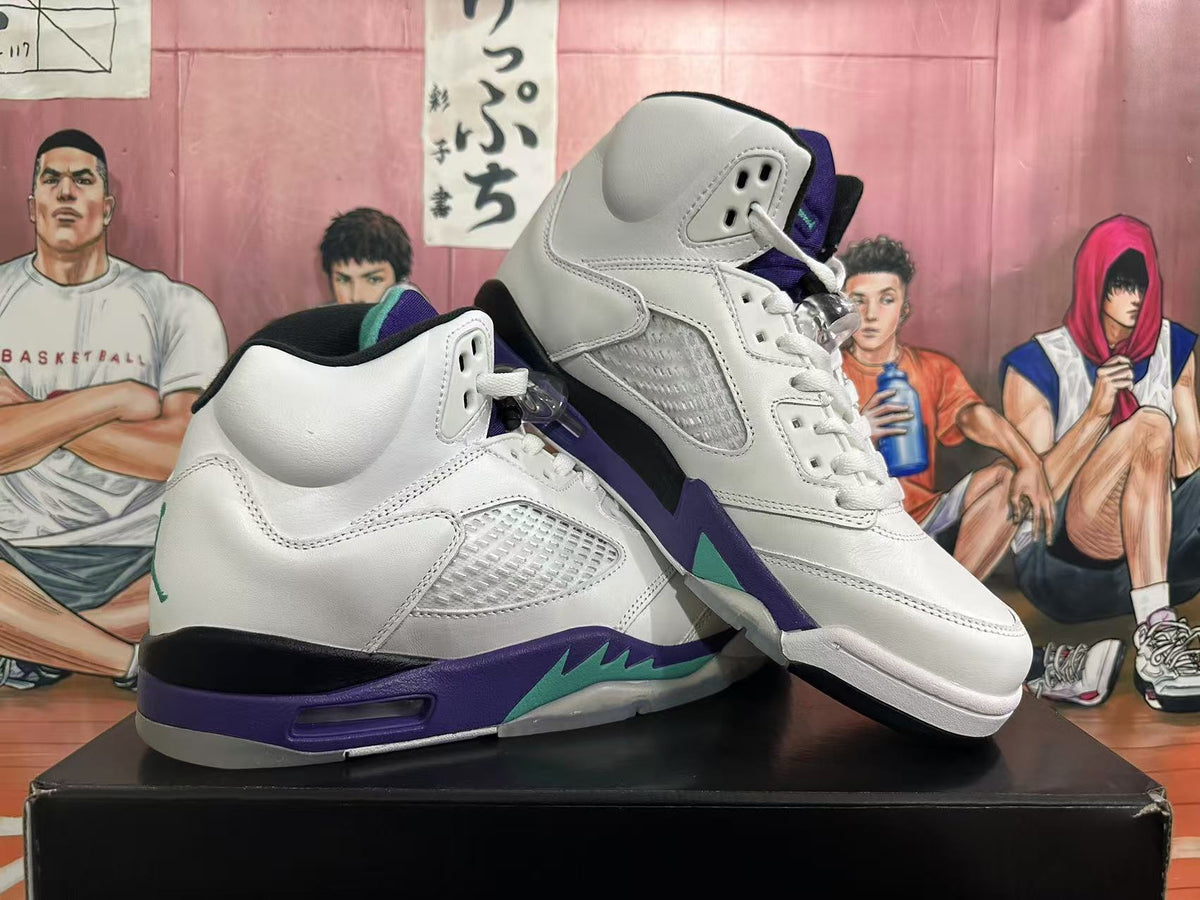 Angled view of a pair of white high-top sneakers with purple and teal accents