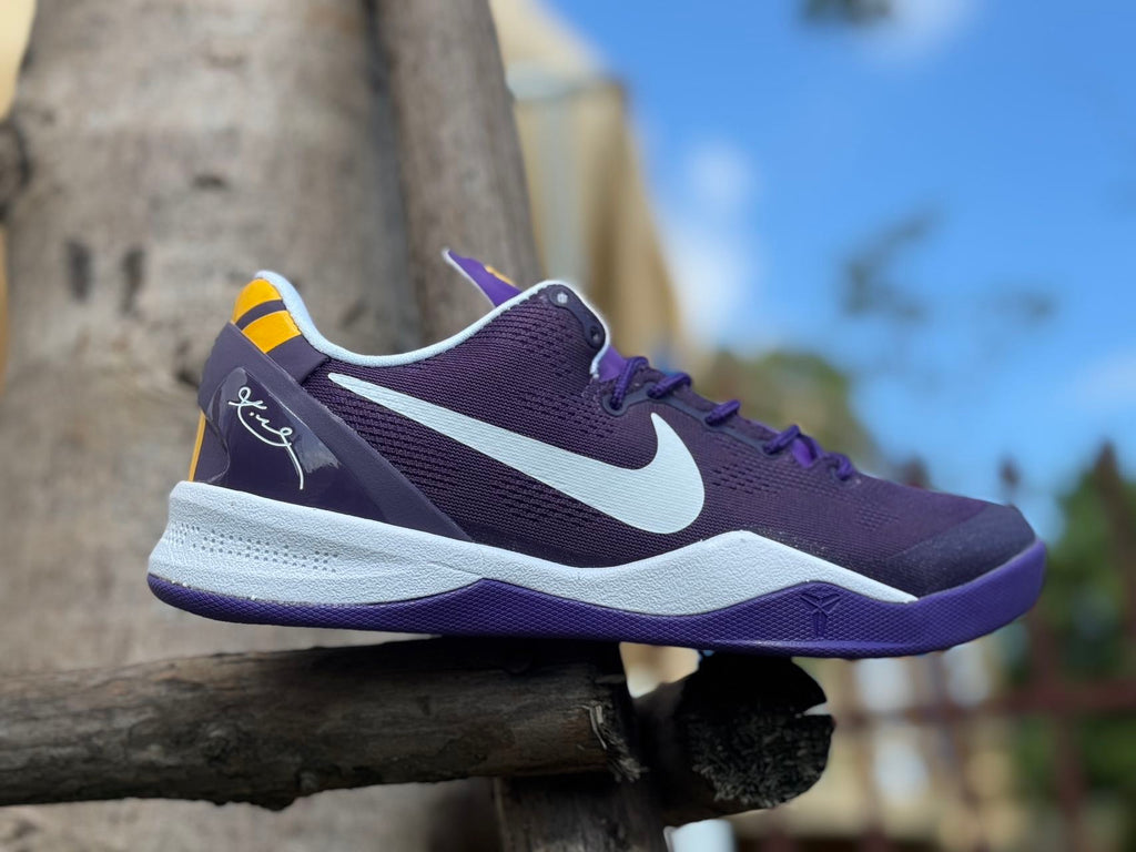 Side profile of a purple Kobe 8 shoe with white Swoosh and midsole.