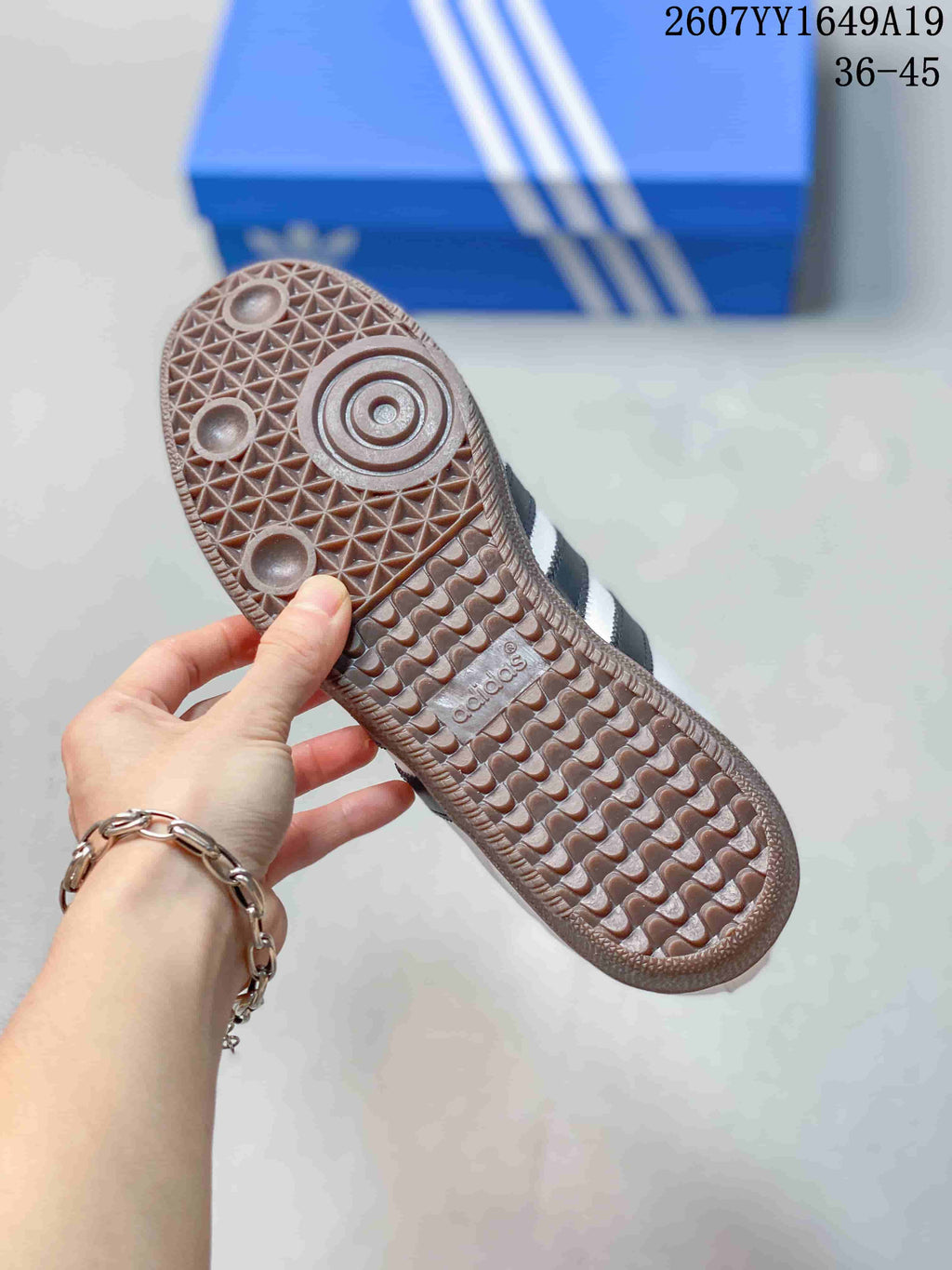 Close-up of the gum-colored outsole showing a geometric tread pattern and adidas branding.