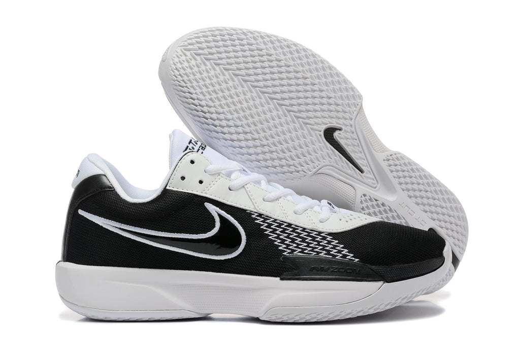 Side and outsole views of black and white Nike G.T. Cut Academy shoes.