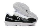 Side and outsole views of black and white Nike G.T. Cut Academy shoes.