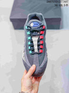 Top view of a Nike Air Max 95 sneaker showing the layered upper and contrasting teal and pink lace loops.