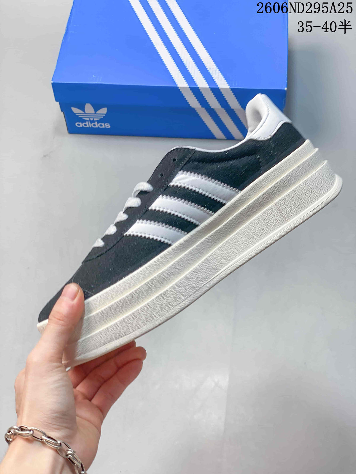 Side view showing the dark navy upper, white three-stripe detailing, and thick layered platform sole.