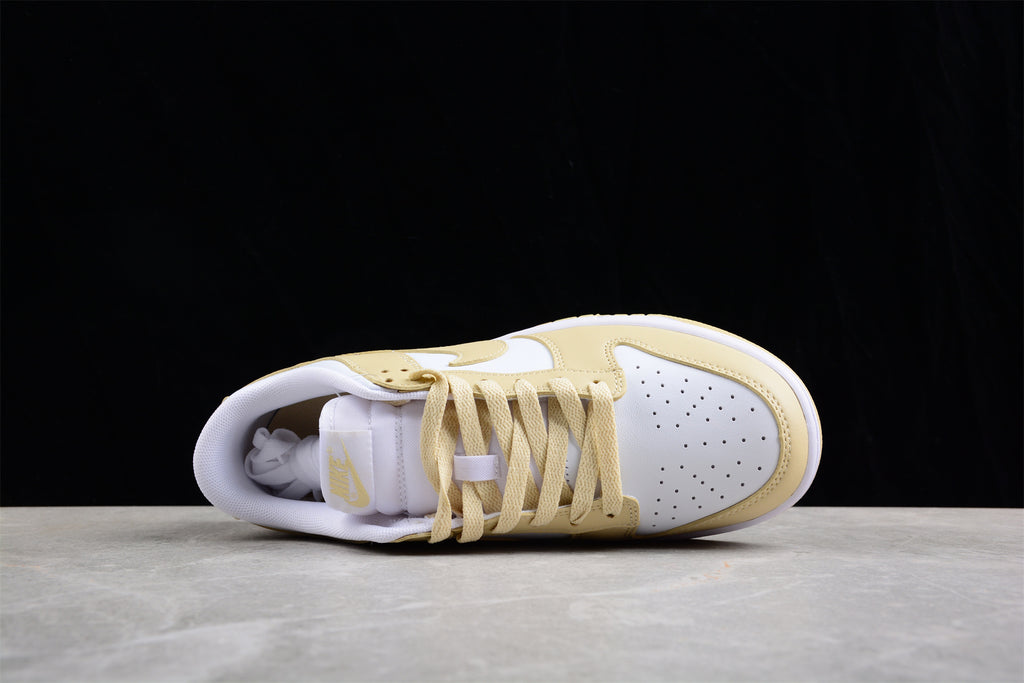 Top view of one sneaker showing the perforated toe box, cream laces, and padded collar.