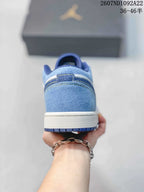 Rear view showing the light blue heel, layered stitching, white midsole, and blue outsole.