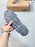 View of the dark textured outsole with multiple circular traction details and New Balance branding; the image also shows style code 2607JGD546A16 and size range 36–41.