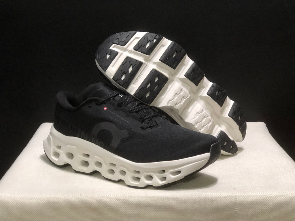Angled view showing the black outsole tread and open midsole structure of the sneakers.