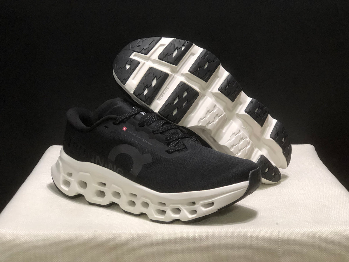 Angled view showing the black outsole tread and open midsole structure of the sneakers.