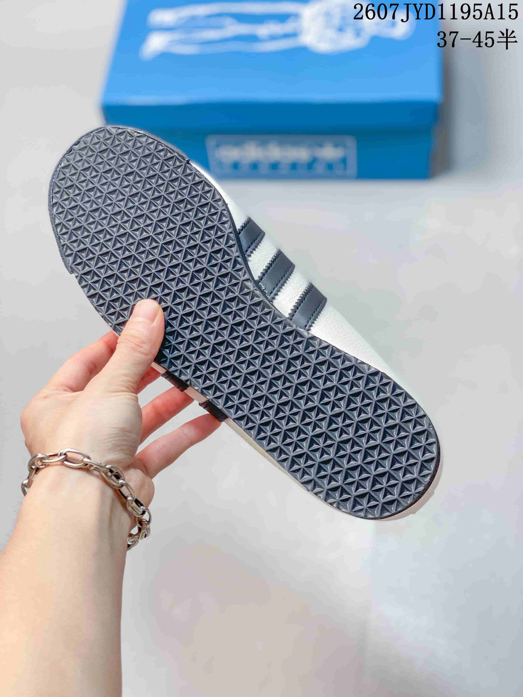 Close-up of the sneaker outsole showing a dense geometric tread pattern.