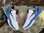 Top view of the pair highlighting the black tongues and pink laces.