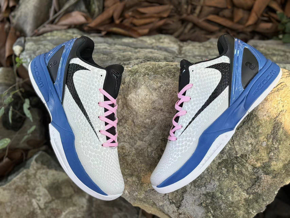 Top view of the pair highlighting the black tongues and pink laces.