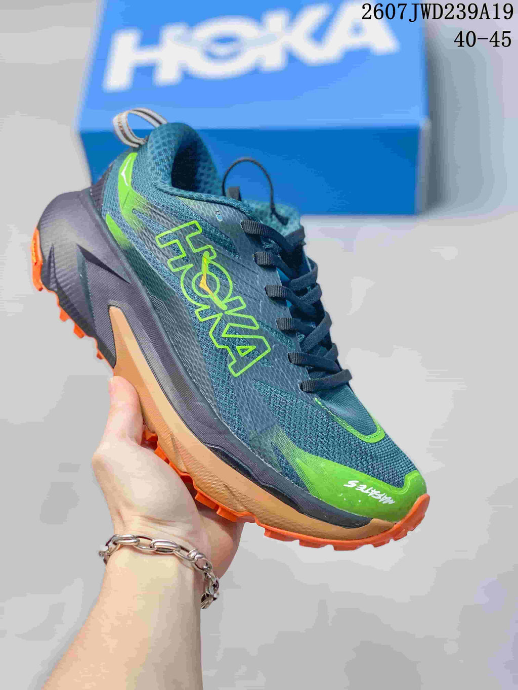 Dark gray and neon green HOKA Rocket X 3 running shoe with orange outsole accents; image text shows code 2607JWD239A19 and sizes 40–45.