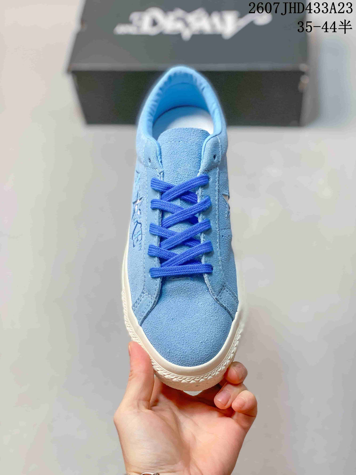 Top view of the light blue sneaker showing the rounded toe, blue laces and low-top collar.