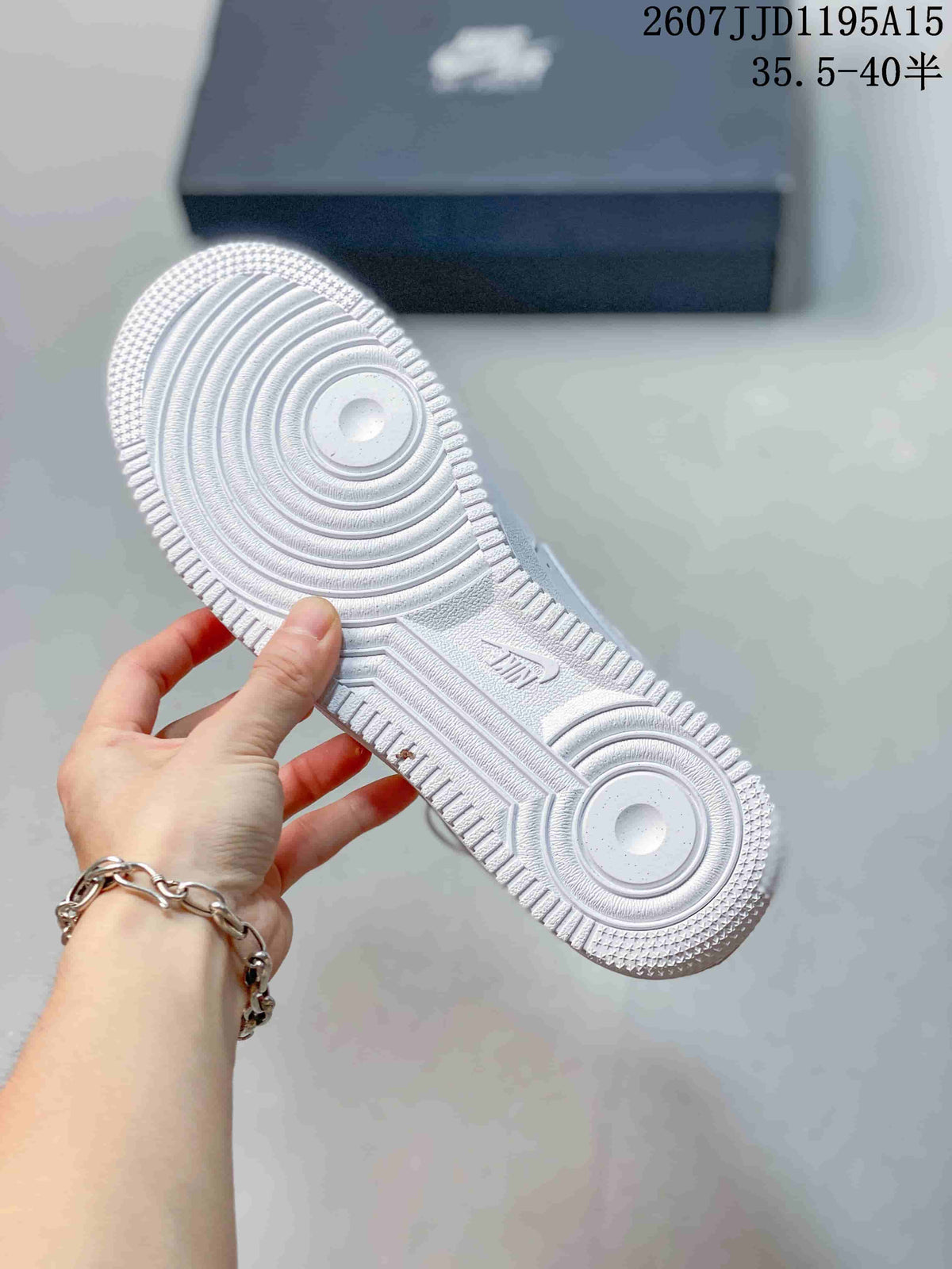 Close-up of the white textured rubber outsole with circular traction patterns and a visible embossed Nike Air mark.